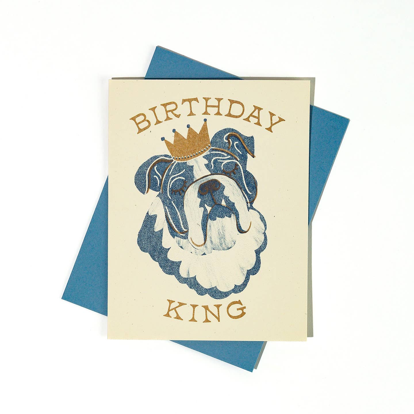 Greeting card with cream background and image of a blue and cream bull dog wearing a gold crown and gold text says, "Birthday King". Blue envelope included.