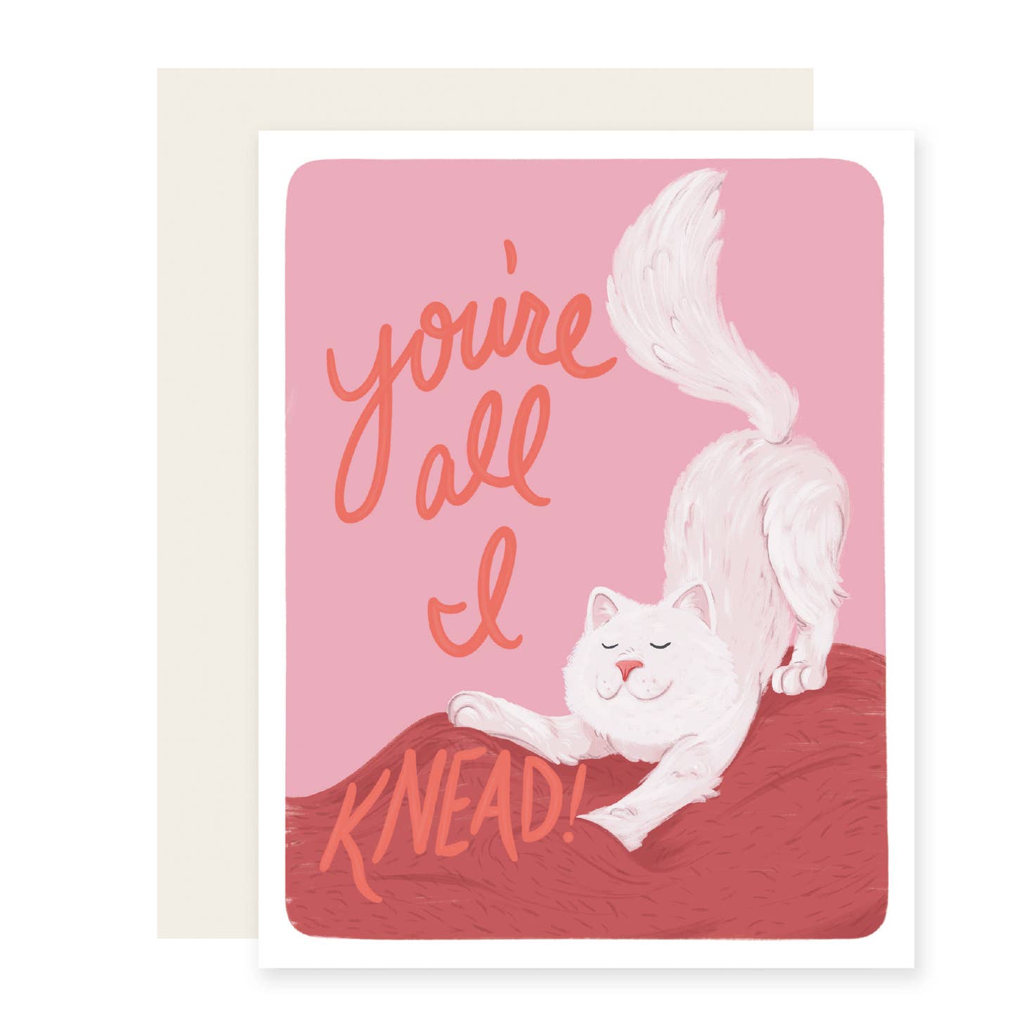 Greeting card with pink and red background and image of a white cat kneading the blanket with red text says, "You're all I knead!". White envelope included.