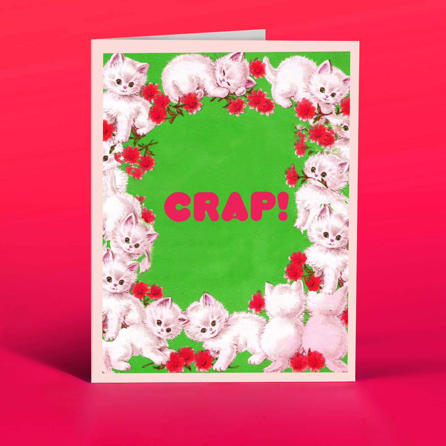 Greeting card with green background and images of white fluffy kittens and red text in center of card says, "Crap!". Envelope included.