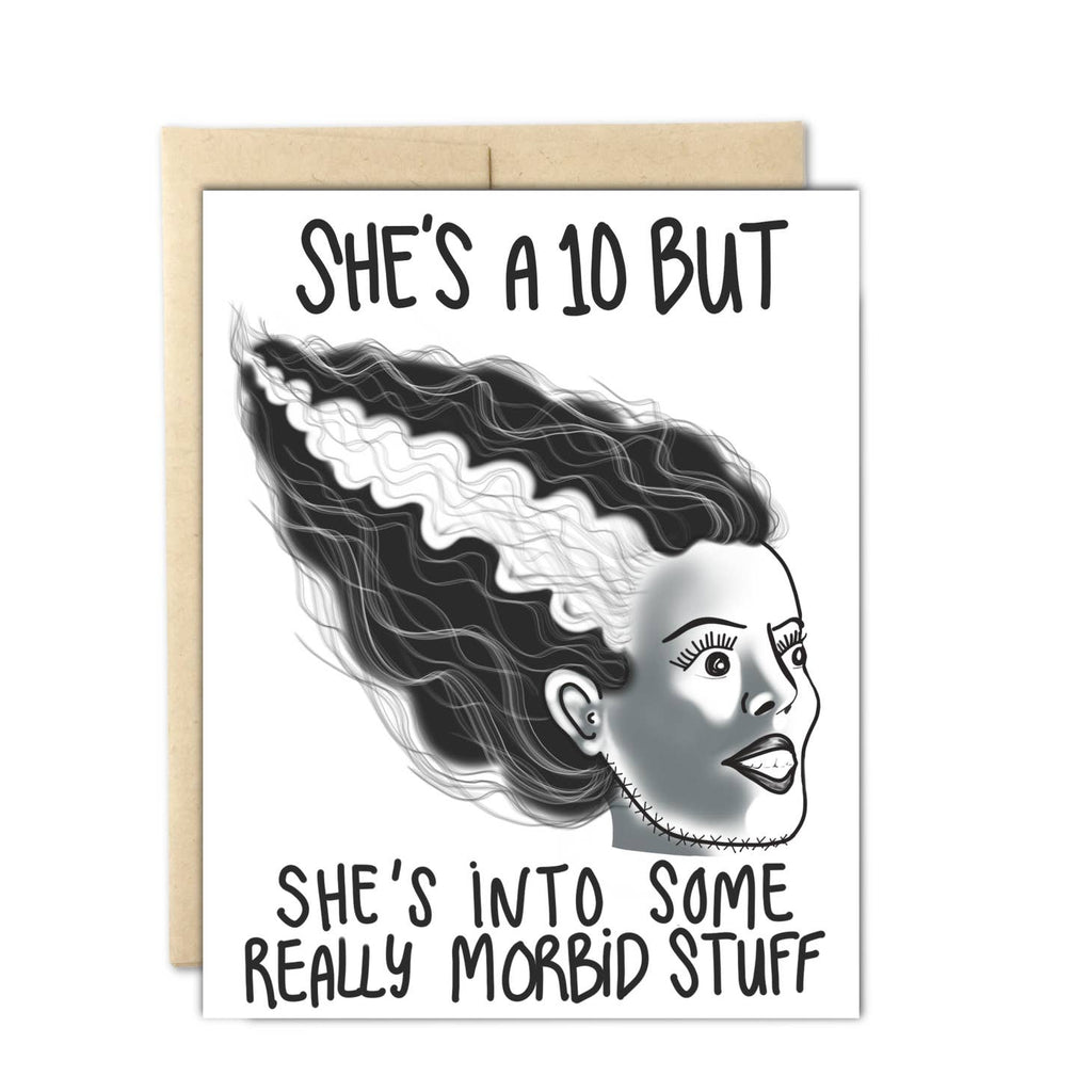 White background with image of the head of the bride of Frankenstein with black text says, "She's a 10 but she's into som really morbid stuff". Kraft envelope included. 