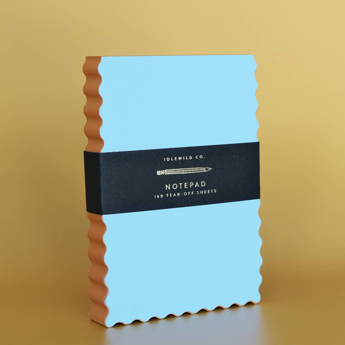 Notepad with blue background and orange wavy edging. 
