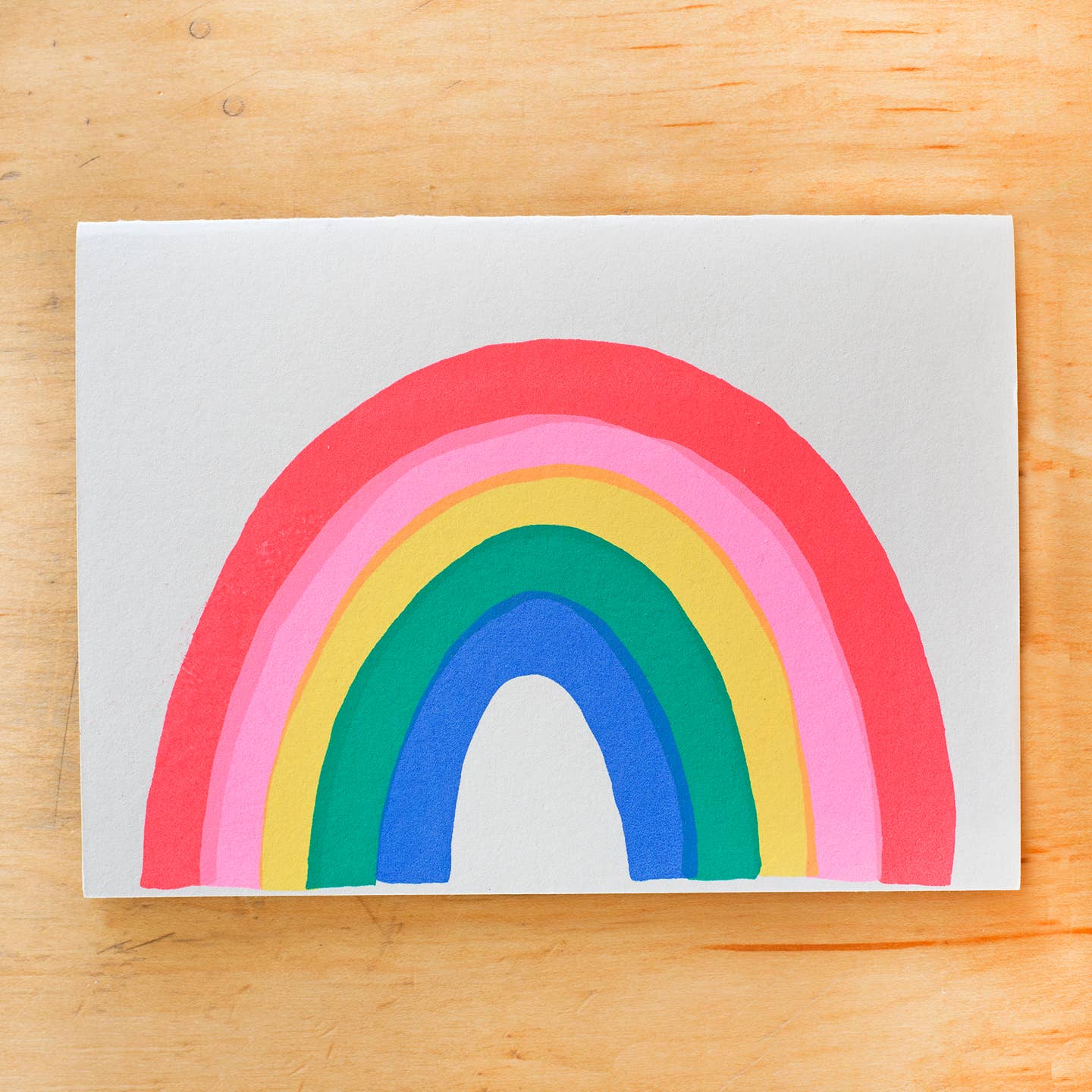 Greeting card image of grey background with vibrant rainbow in hot pink, pink, yellow, green and blue. Envelope included. 