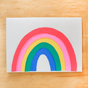 Greeting card image of grey background with vibrant rainbow in hot pink, pink, yellow, green and blue. Envelope included. 