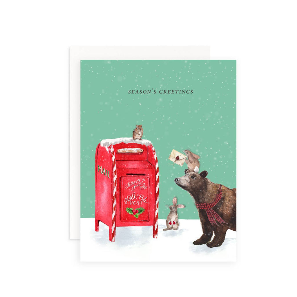 Greeting card with mint green background and image of red mailbox with bear, bunnies and chipmunk mailing a letter. Black text says, "Season's Greetings". White envelope included. 