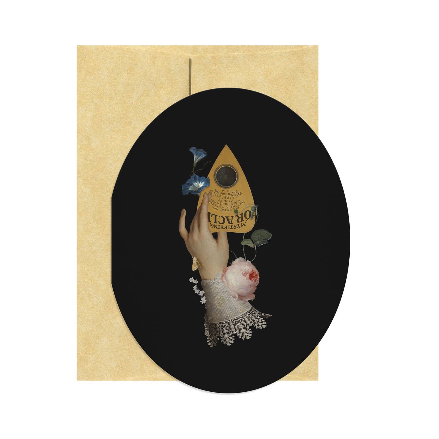 Oval shaped greeting card with black background and image of a hand holding a planchette with flowers and a lace cuff. Tan envelope included.