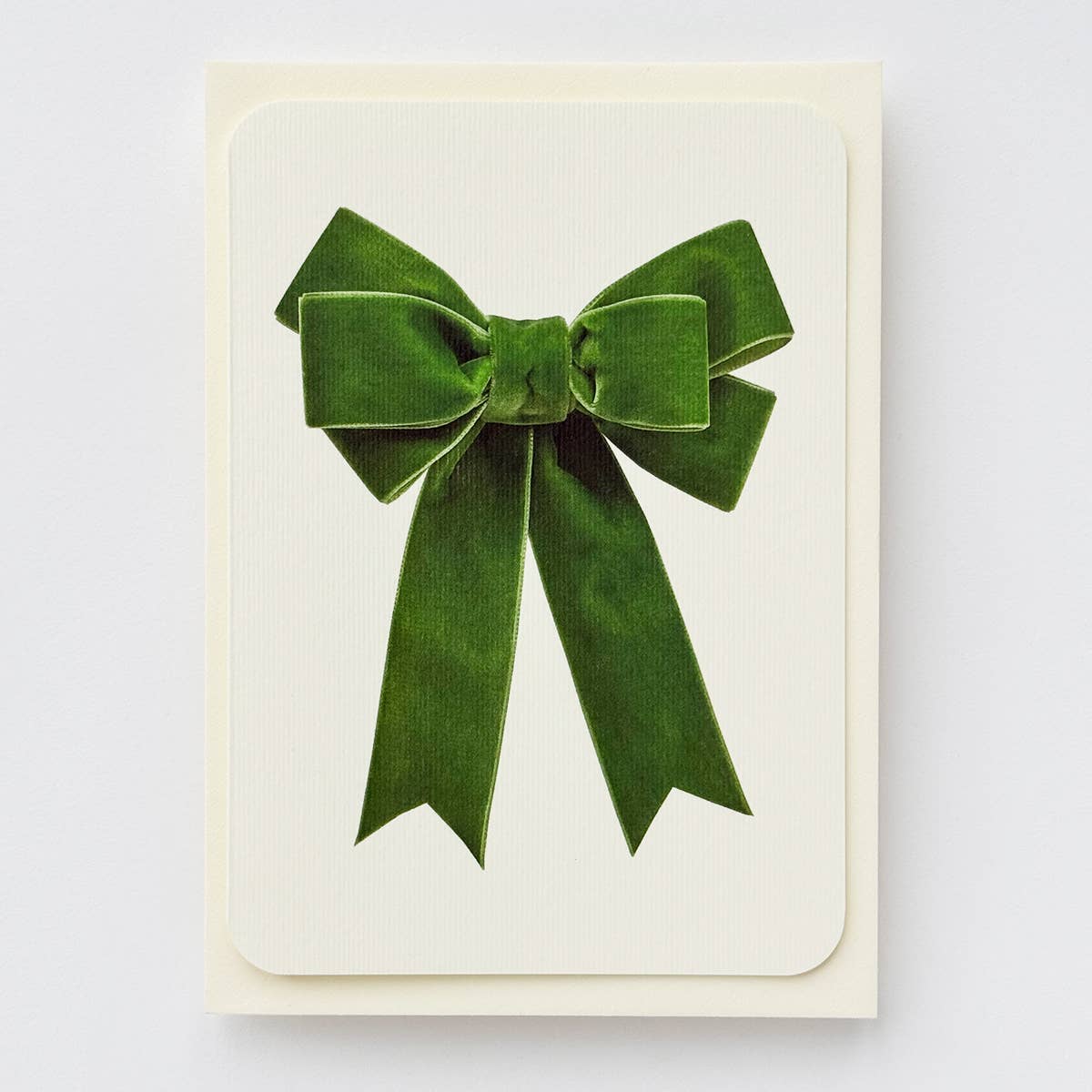 Greeting card with image of a green velvet bow on cream background. Envelope included. 