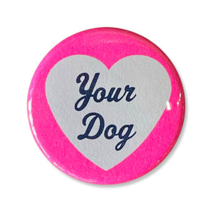 Image of button with pink border and white heart with blue text says, "Your dog". 