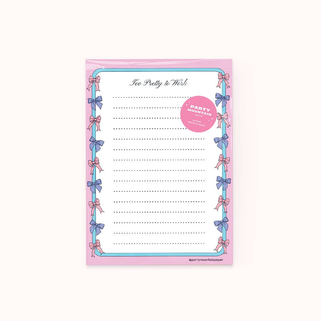 Notepad with white background with pink border and blue stripe with pink and blue bows around border. Dotted lines for writing and black text at top of pad says, "Too pretty to work". 