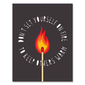 Greeting card with black background and image of a match on fire with white text says, "Don't set yourself on fire to keep others warm".  Envelope included