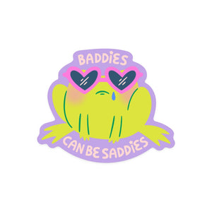 Image of green frog wearing pink heart shaped sunglasses and a blue tear drop with pink text says, "Baddies can be baddies". 