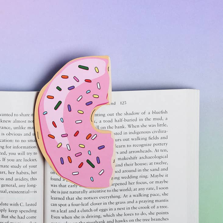 Image of bookmark in shape of half of pink frosted donut with sprinkles. 