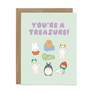 Greeting card with mint background and images of little animal treasures and lilac text says, "You're a treasure!". Envelope included.