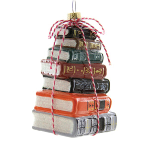 Image of a stack of books tied with a red and white string. 