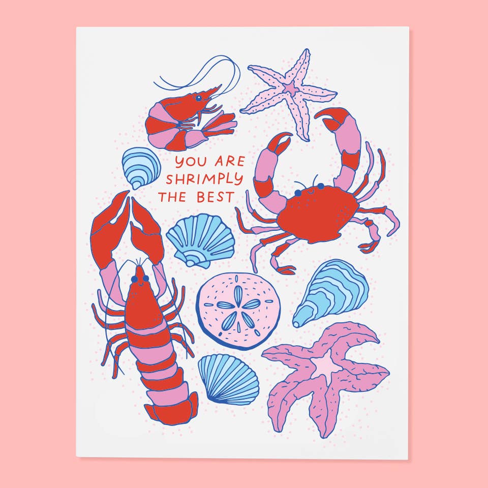 Greeting card with white background and images of shrimp, crab, lobster and shells in red, pink, and blue. Red text says, "You are shrimply the best". Envelope included.