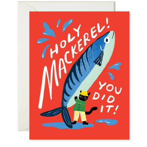 Greeting card with red background with image of a big blue mackerel held by a black cat wearing a green jacket and yellow hat. White text says, "Holy mackerel! You did it!". Envelope included. 