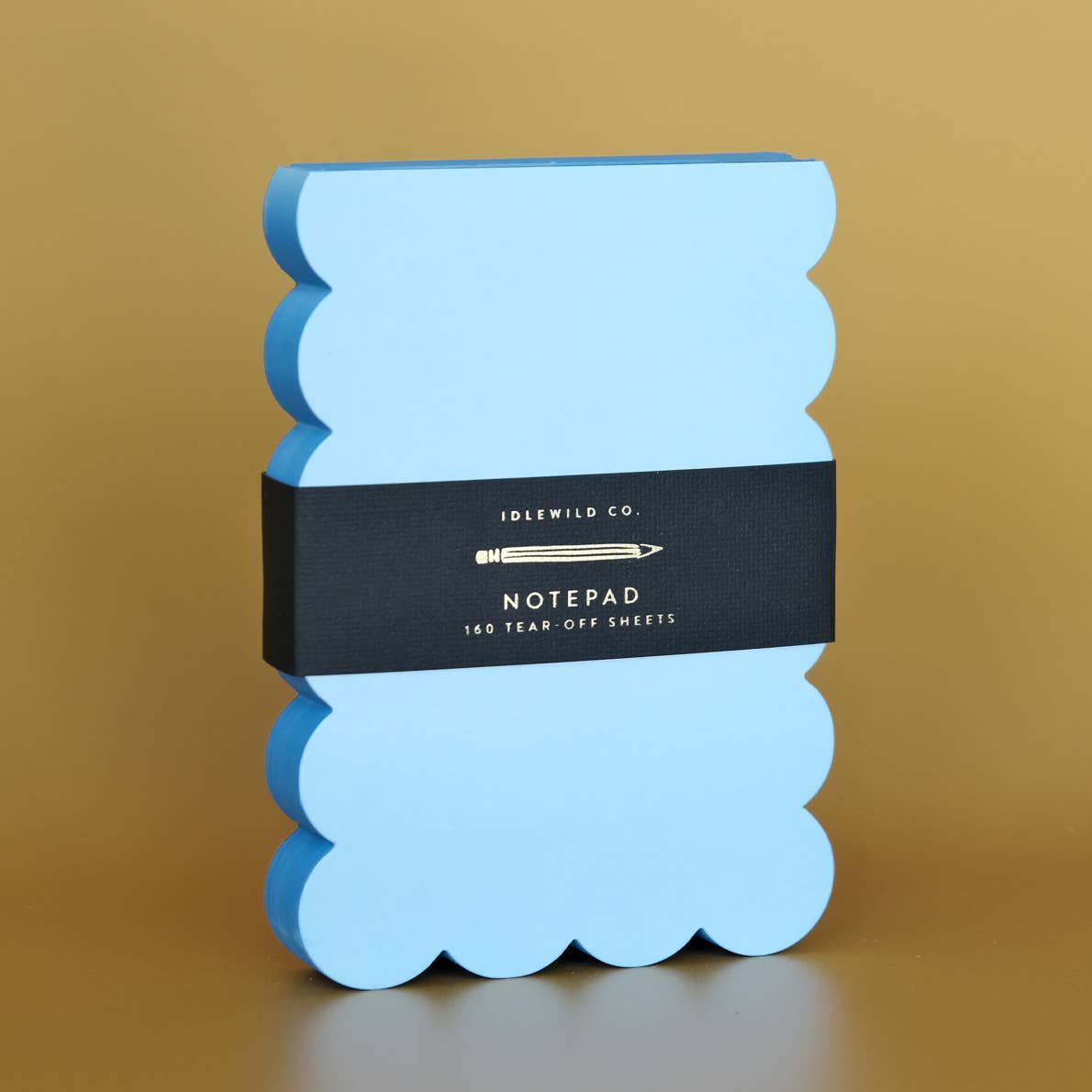 Notepad with blue pages and darker blue scalloped edges.