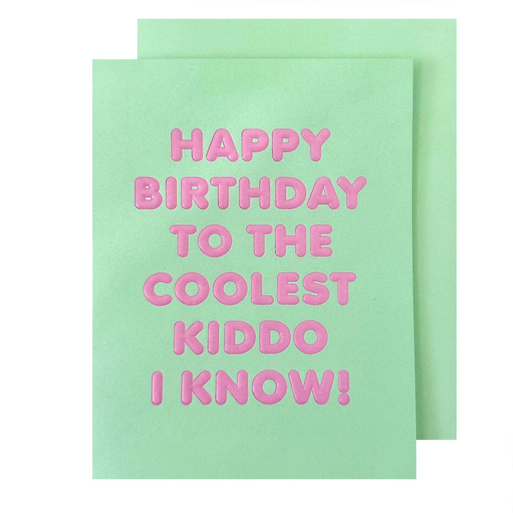 Greeting card with mint green background and pink text says, "Happy Birthday to the coolest kiddo I know!". Mint green envelope included. 