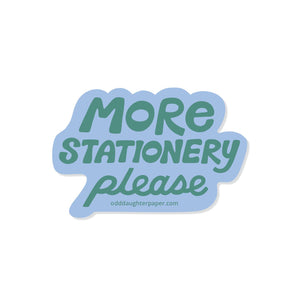 Decorative sticker with blue background and green text says, "More stationery please". 