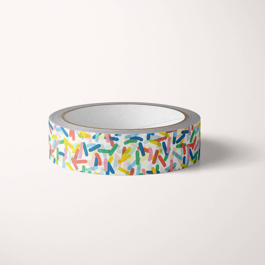 Washi tape with white background and aqua, pink, blue, red and yellow sprinkles.