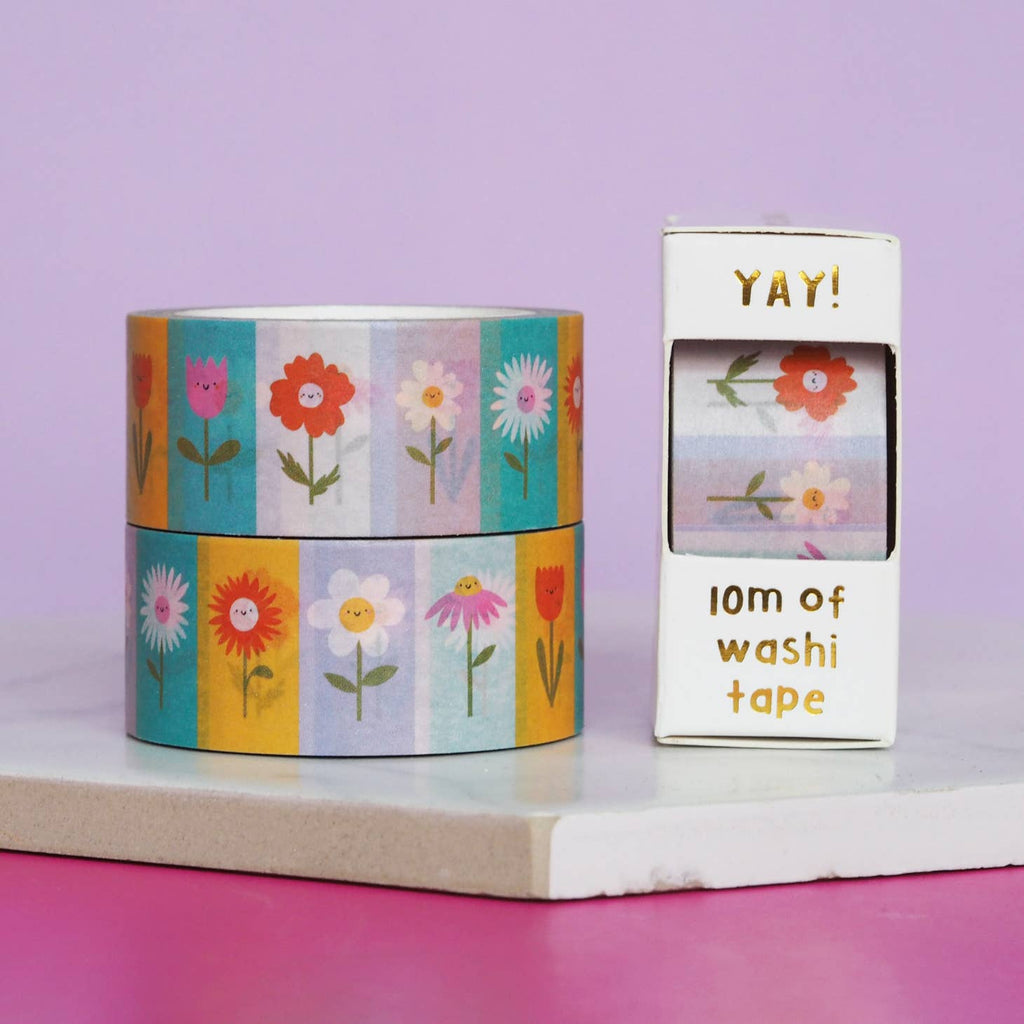 Image of rolls of tape in color blocks of pink, aqua, yellow and ivory with flowers in each box in corresponding colors. 