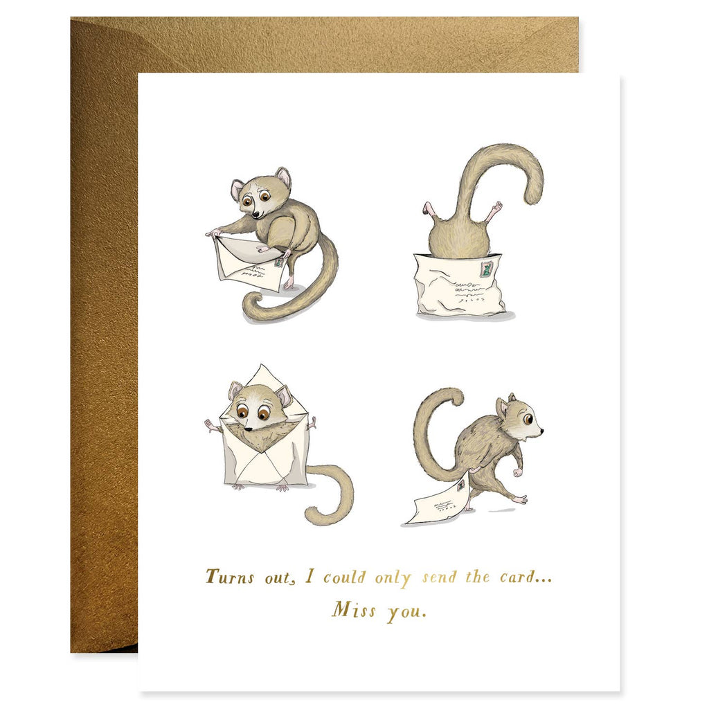 White background with images of lemur trying to mail itself in an envelope. Gold text says, "Turns out, I could only send the card...Miss you". Kraft envelope included. 