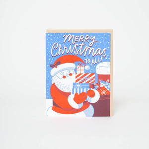 Greeting card with blue background and image of Santa in red and white holding presents and white text says, "Merry Christmas to all!". Kraft envelope included.