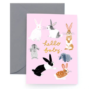 Greeting card with pink background wit images of rabbits and gold foil text says, "Hello Baby". Grey envelope included. 