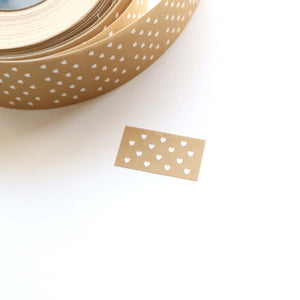 Label sticker with tan background and white dots. 