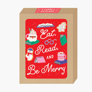 Boxed set of greeting cards with red background and images of cookies, cocoa, books, and glasses with white text says, "Eat, Read, and be merry". Envelopes included. 