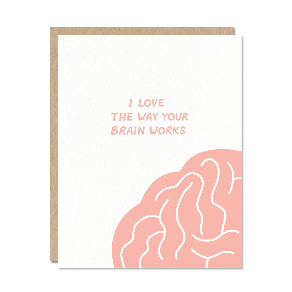 Greeting card with white background and image of pink brain in bottom right corner with pink text says, "I love the way your brain works". Kraft envelope included. 