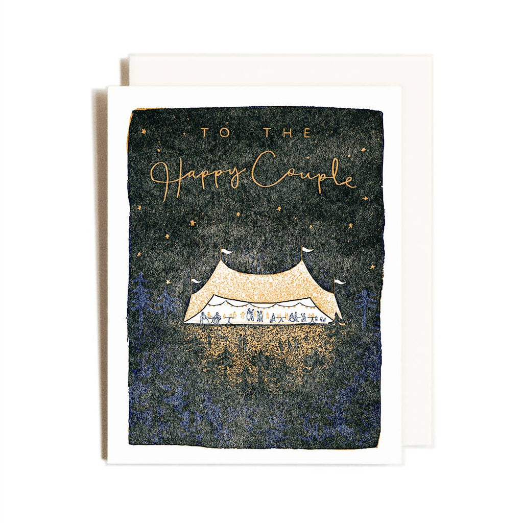 Greeting card with black background and cream border with image of a gold tent with a wedding underway. Gold text says, "To the happy couple". Cream envelope included. 