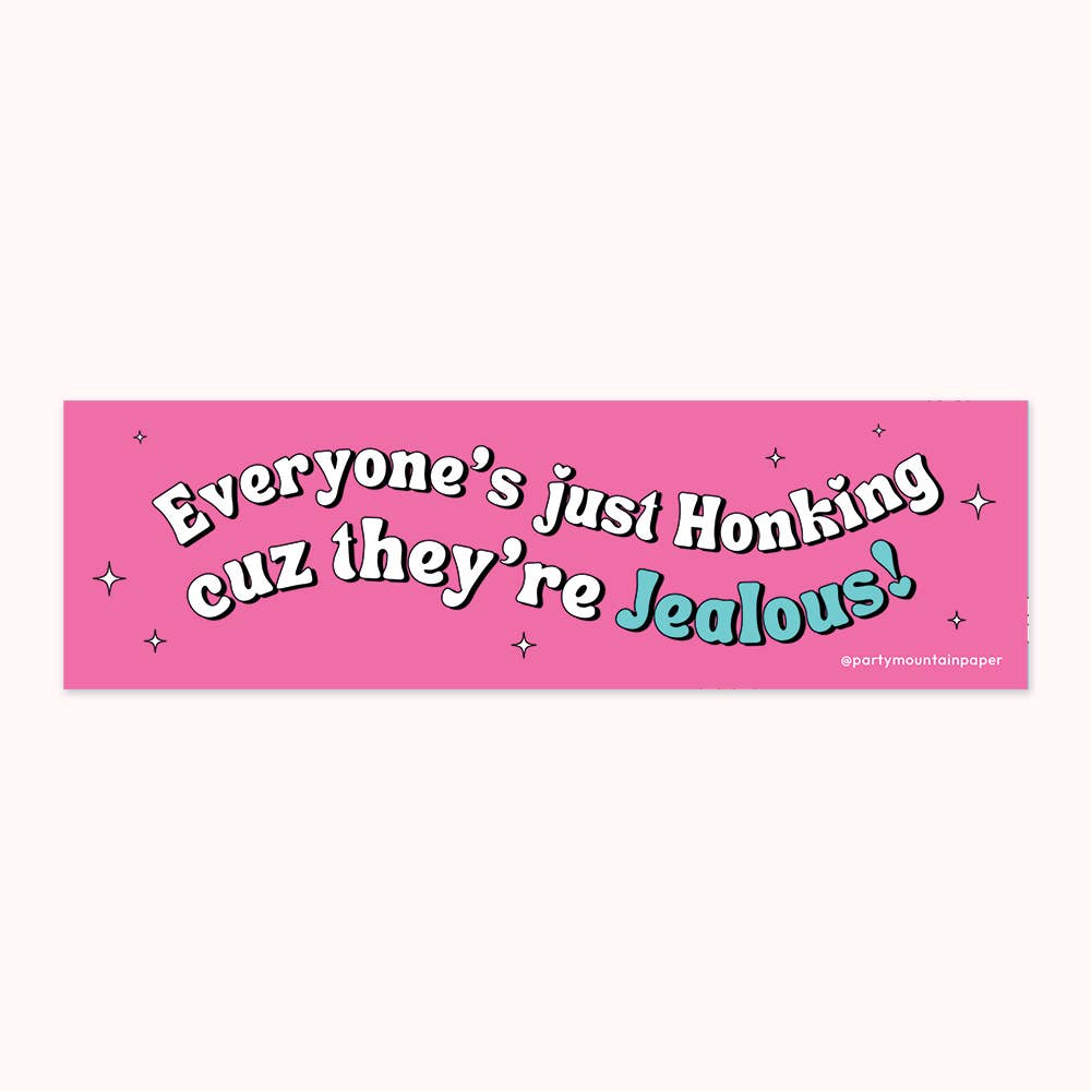 Bumper sticker with pink background and white text says, "Everyone's just honking cuz they're" and blue text says, "jealous!". 