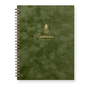 Forest green cover with gold foil text says, "Curiosities & Other Oddities" and an image of a beetle.