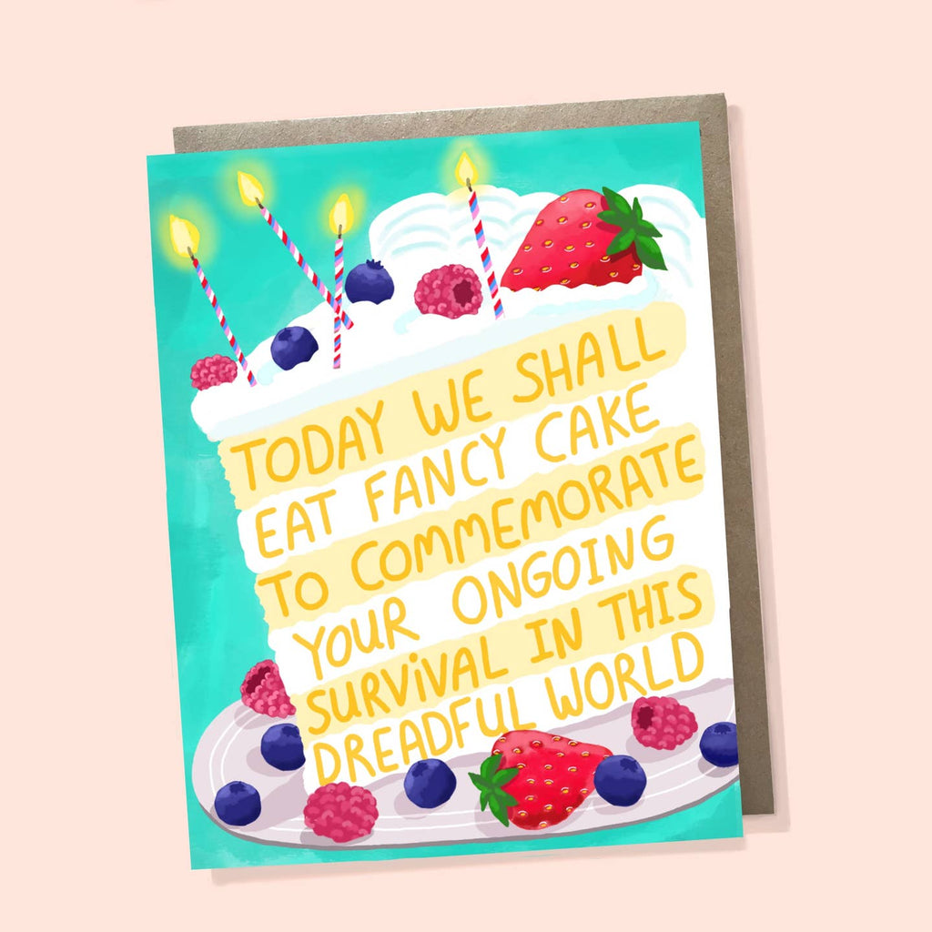 Greeting card with teal background and image of piece of cake in yellow and white with strawberries and blueberries on it with candles. Yellow text says, "Today we shall eat fancy cake to commemorate your ongoing survival in this dreadful world". Envelope included. 