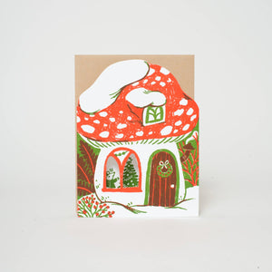 Greeting card in shape and image of mushroom house with Holiday trimmings in red, green and white. Kraft envelope included. 