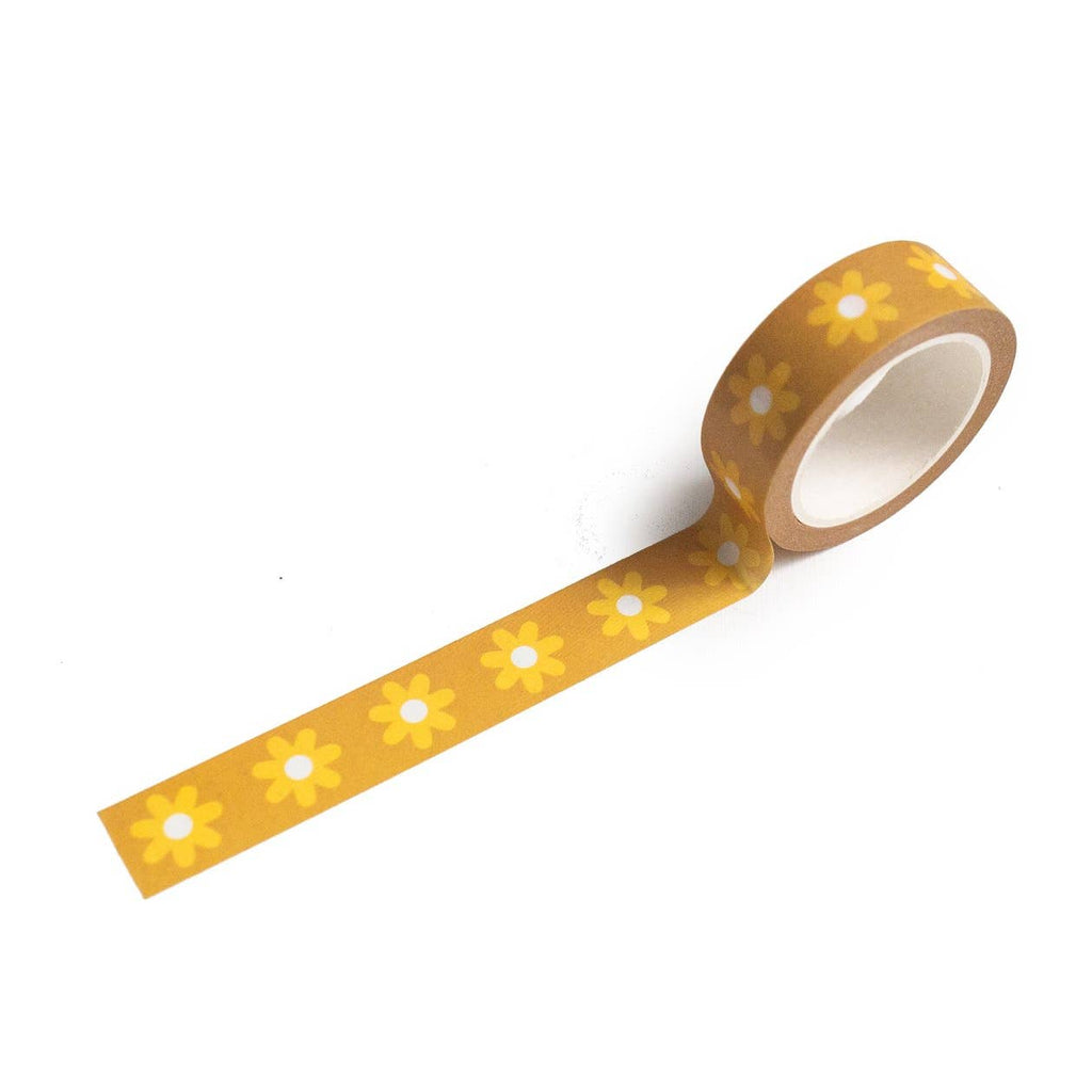 Image of roll of washi tape with gold background and images of yellow daisies with white centers.