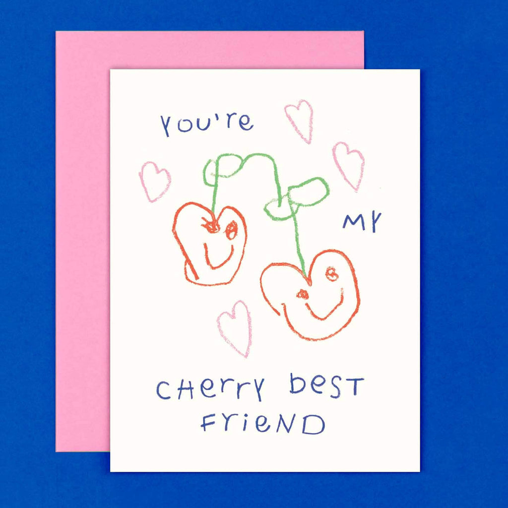 Greeting card with white background and drawing of child like two cherries and pink hearts with blue text says, "You're my cherry best friend". Pink envelope included. 