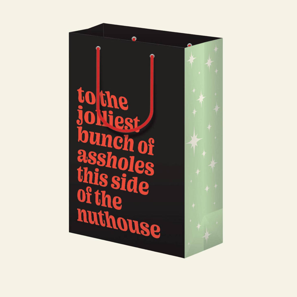 Black background with red text says, "to the jolliest bunch of assholes this side of the nuthouise". Red cord handle and green and white sides of bag. 