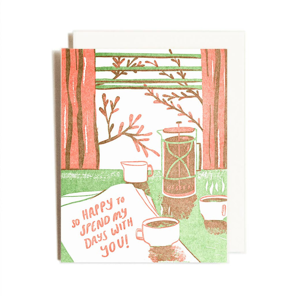 greeting card depicting a table with coffee cups and a newspaper with an open window in the background. Text says "So happy to spend my days with you"