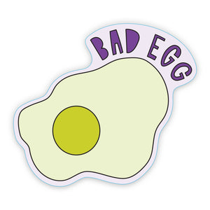 Decorative sticker in image of a fried egg in yellow and purple border with purple text says, "Bad egg". 