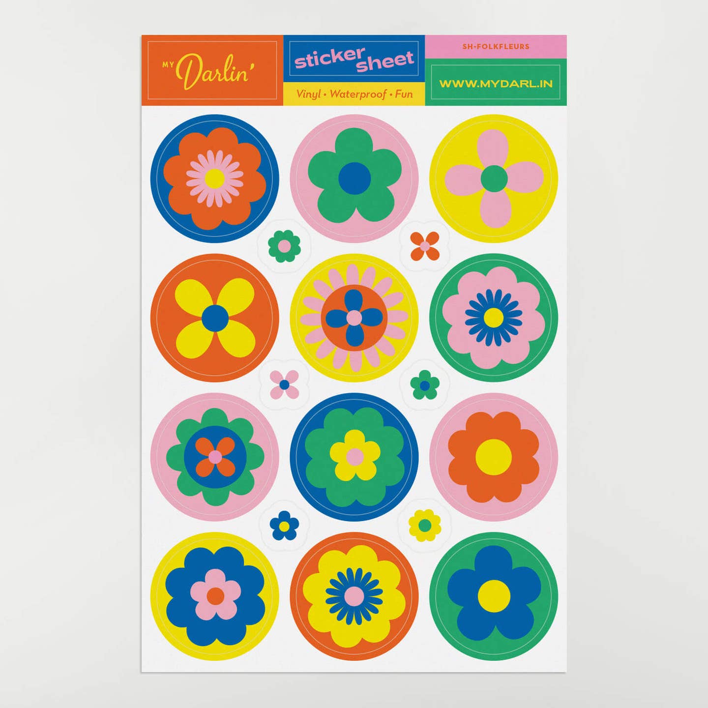 Decorative sticker sheet with images of circular stickers with flowers in pink, red, blue, green and yellow.