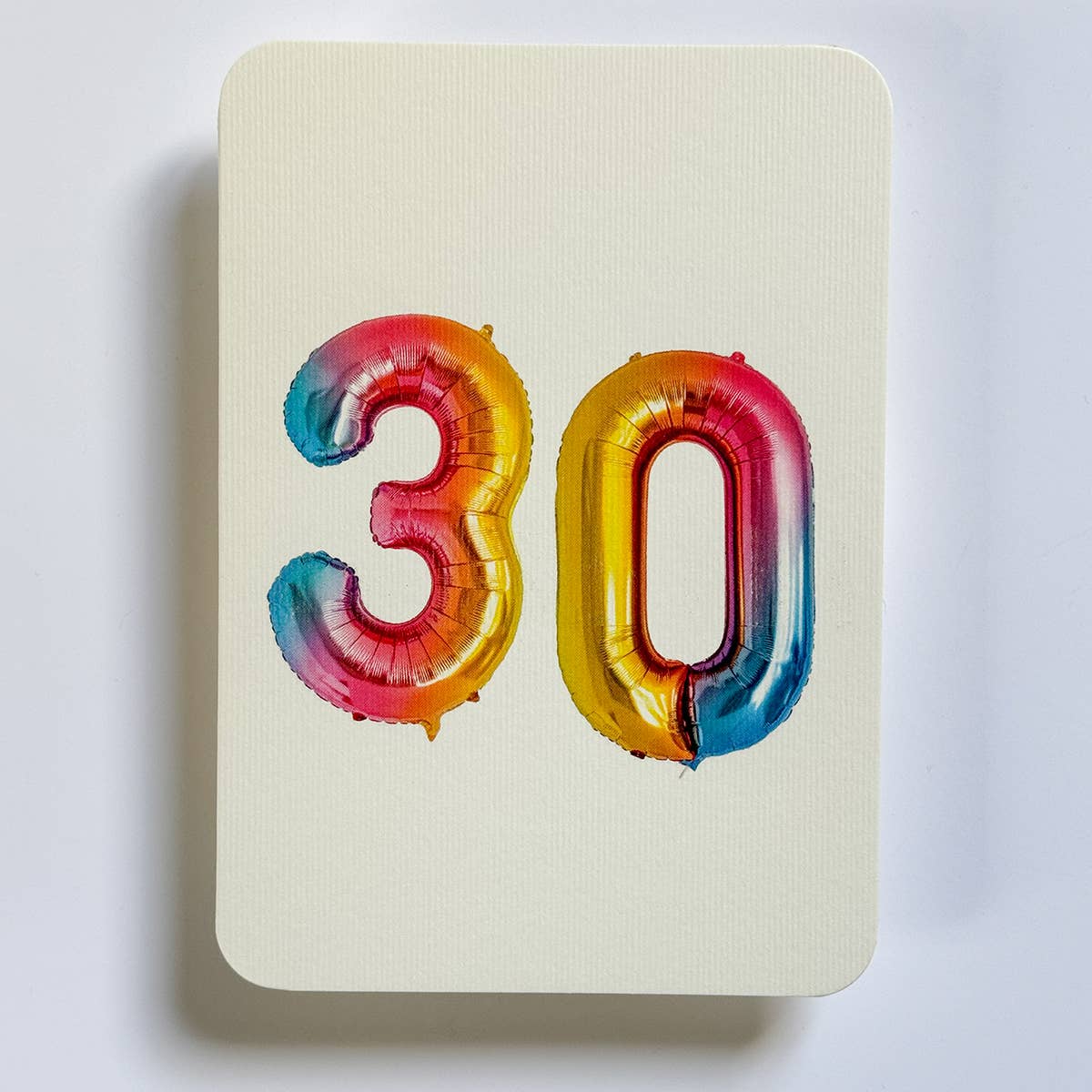 Greeting card with cream background and image of balloons "30". Envelope included.