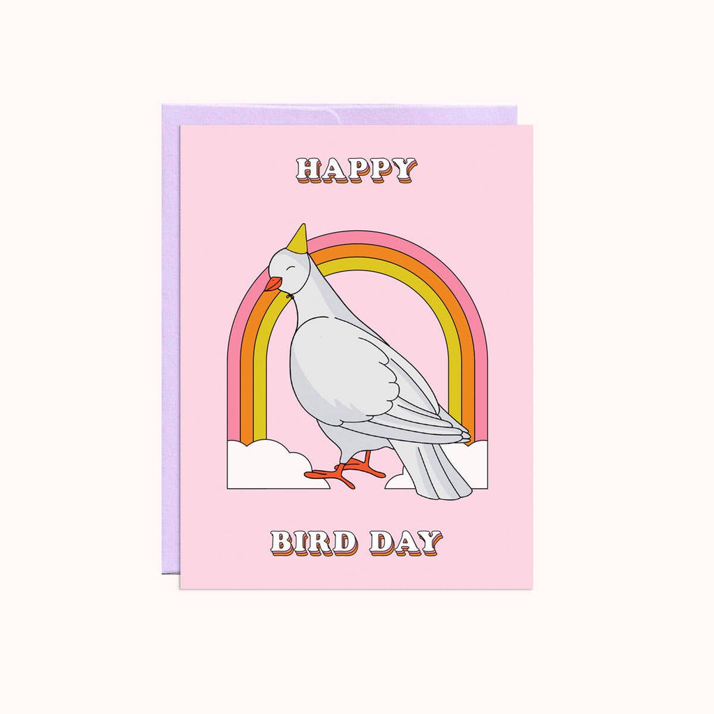 Greeting card with pink background and image of a white bird wearing a party hat with a pink, orange and yellow rainbow and white clouds. White text says, "Happy Bird Day". Lilac envelope included. 