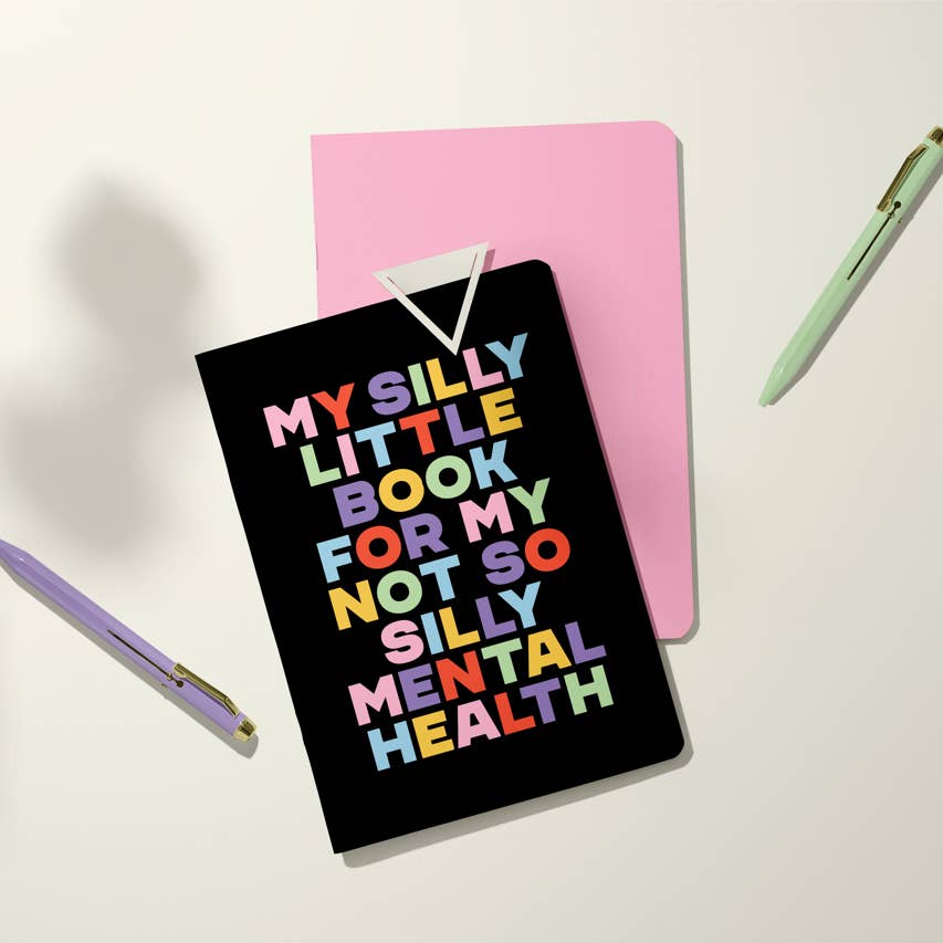Black background with rainbow text says, "My silly little book for my not so silly mental health".