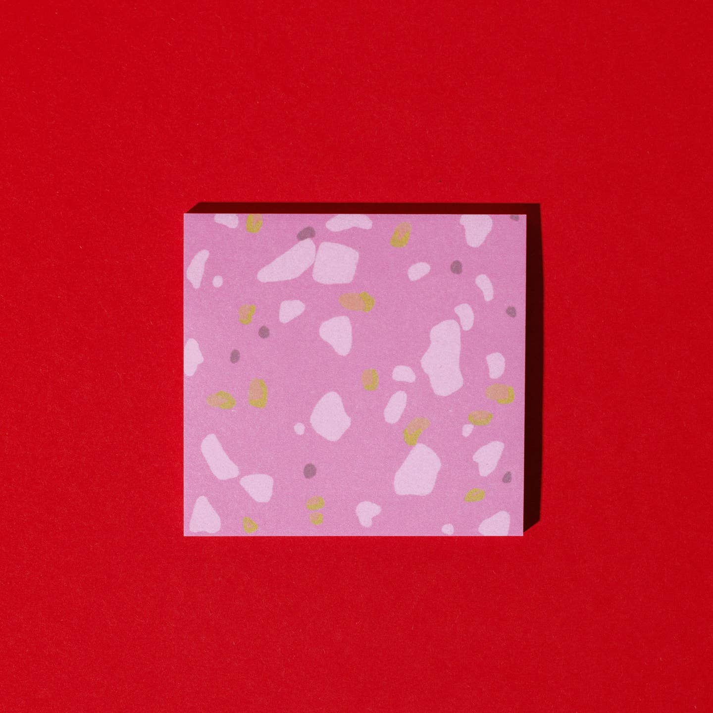 Sticky note pad with pink background and flecks of color in pink, yellow and burgundy to look like deli meat.