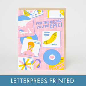 Greeting card with pink background and images of record albums in blue, yellow and white. Blue text says, "For the record you're epic!". Kraft envelope included. 