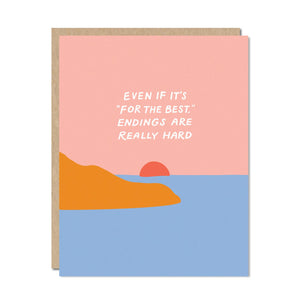 Pink sky and blue water with setting orange sun and orange mountain. White text says,”Even if it’s ‘for the best’. Endings are really hard”. Kraft envelope is included.  