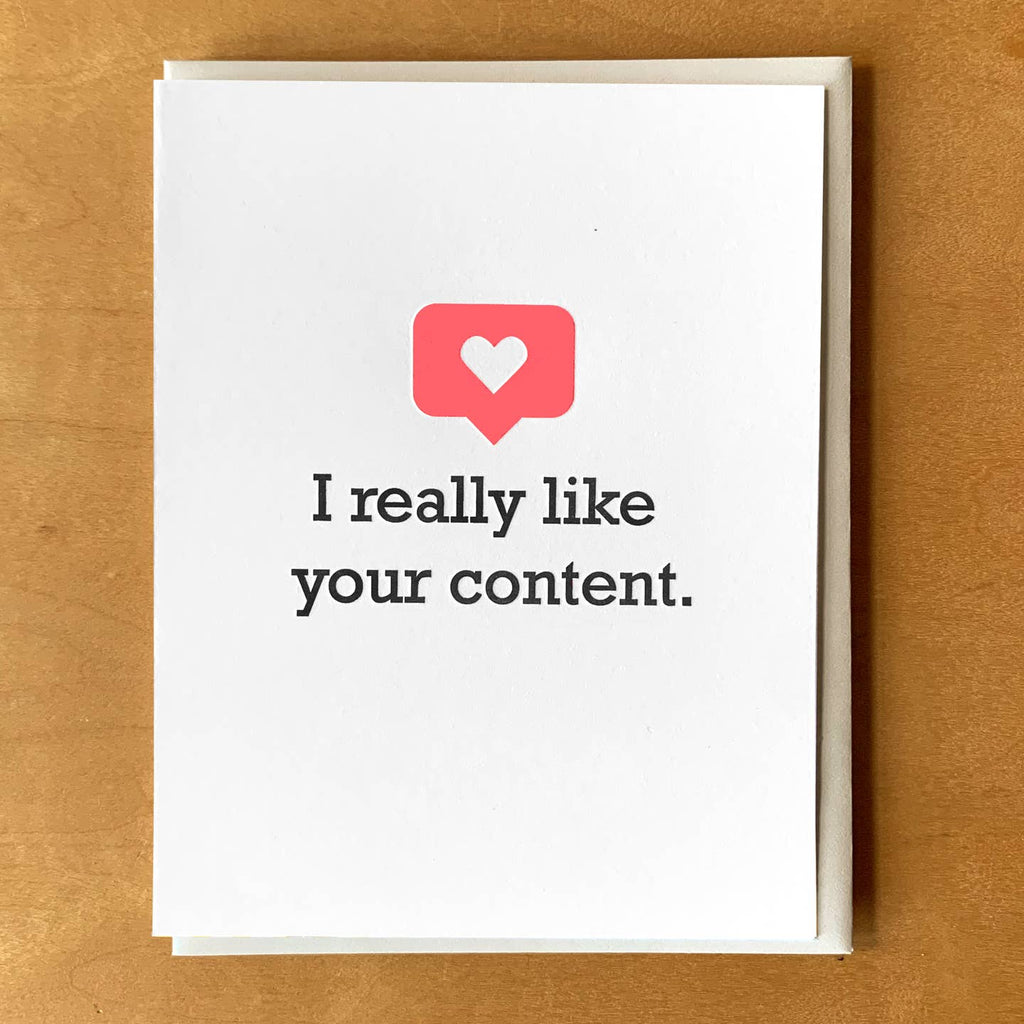 Greeting card with white background with black text says, "I really like your content." Tan envelope included.