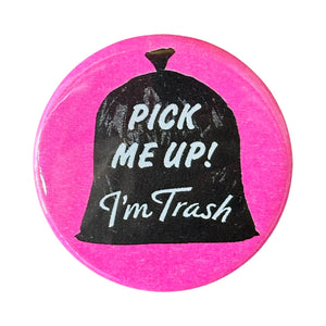 Image of button with neon pink background and an image of black bag of trash with white text says, "Pick me up! I'm trash". 