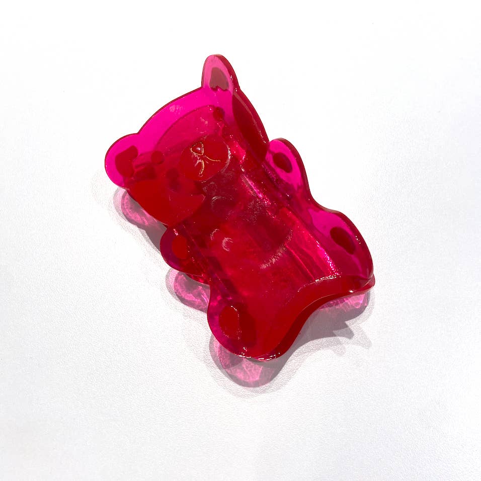 Image of red gummy bear with gold detailing. 